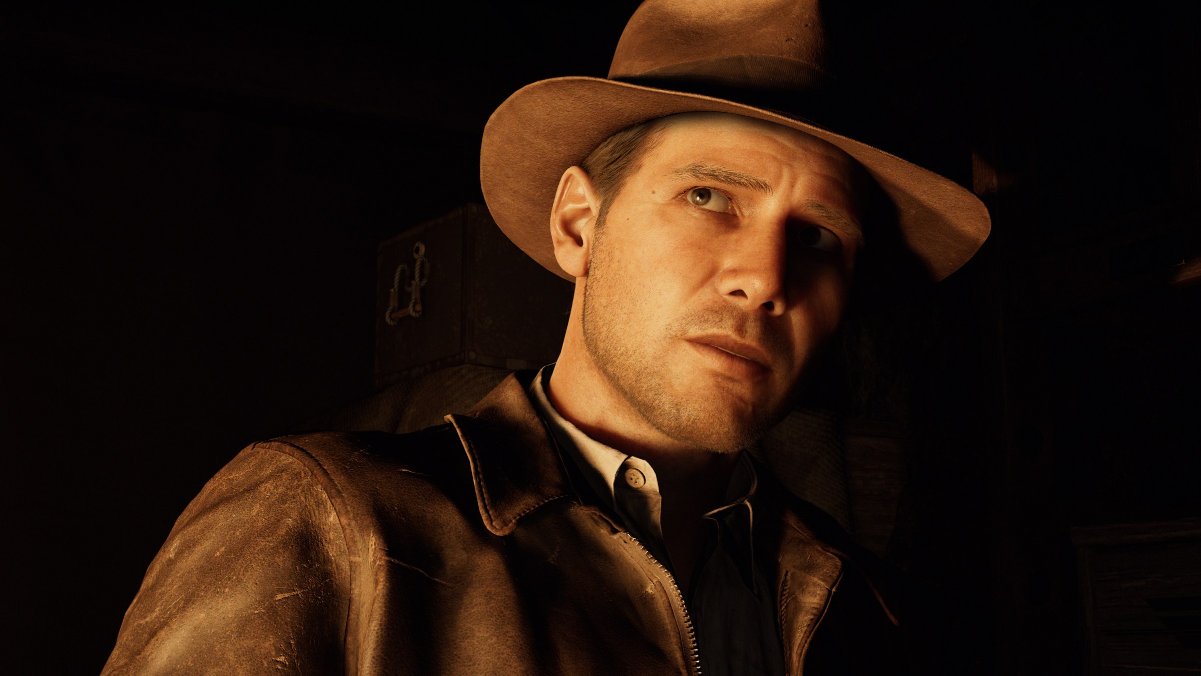 a close-up of Indiana Jones, wearing his typical adventurer outfit with a brown leather jacket and brown fedora, lit by firelight in Indiana Jones and the Great Circle